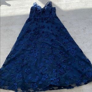 Striking midnight blue gown sewn with petals.